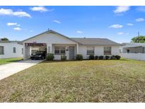 Charming single-story home with a covered parking area and well-maintained landscaping at 1647 Crestlawn Ave, Orlando, FL 32811