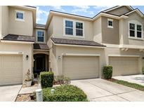 A beautiful townhome with a well-kept lawn, an attached garage, and lovely curb appeal at 178 Windflower Way, Oviedo, FL 32765