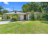 Charming single-story home featuring a quaint front yard and a convenient carport at 1877 Attucks Ave, Orlando, FL 32811