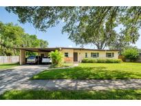 Charming single-story home with a well-manicured lawn and covered carport at 1901 Loch Berry Rd, Winter Park, FL 32792