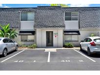 Charming townhouse with well-maintained landscaping and dedicated parking spaces out front at 1940 S Conway Rd # 8, Orlando, FL 32812