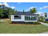 Charming renovated bungalow featuring black and white exterior paint and new windows at 209 N 14Th St, Leesburg, FL 34748