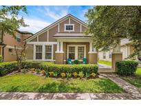 Charming home featuring a landscaped front yard, inviting entrance, and exterior with a modern color palette at 2246 Florida Soapberry Blvd, Orlando, FL 32828