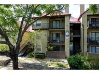 Condominium exterior showcasing balconies, a red roof, and verdant landscaping for inviting curb appeal at 234 Afton Sq # 305, Altamonte Springs, FL 32714