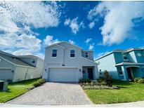 Charming two-story home featuring a brick-paved driveway and manicured front yard at 2855 Alder Berry Blvd, Ocoee, FL 34761