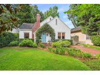 Charming cottage-style home with brick walkway, tidy landscaping, and a quaint blue door at 1008 Delaney Park Dr, Orlando, FL 32806