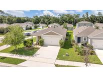 Beautiful single-story home featuring a manicured lawn, charming landscaping, and a two-car garage at 115 Duchess Rd, Deland, FL 32724
