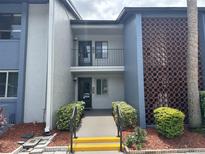 Inviting condo exterior featuring lush landscaping, fresh paint, and a decorative breezeway at 14 Escondido Ct # 134, Altamonte Springs, FL 32701