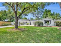 Charming home featuring a well-maintained lawn and inviting curb appeal with mature trees and landscaped surroundings at 1850 Shawnee Trl, Maitland, FL 32751