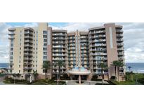 Multi-story beachfront condo building boasts ocean views from private balconies and lush landscaping in a serene setting at 1925 S Atlantic Ave # 411, Daytona Beach, FL 32118