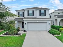 Charming two-story home with a well-manicured lawn, beautiful landscaping, and a two-car garage at 2620 Waterline St, Kissimmee, FL 34743