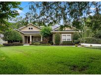 Beautiful one-story home featuring lush green lawn and meticulously landscaped front yard at 2750 Lee Shore Loop, Orlando, FL 32820
