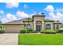 Stunning single-story home with a manicured lawn, arched entryway, and neutral color palette at 289 Laurenburg Ln, Ocoee, FL 34761