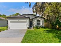 Charming single-story home with a well-maintained lawn, a two-car garage, and curb appeal at 3672 Rollin O Ln, Apopka, FL 32703