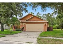 Charming single-story home with a two-car garage and well-maintained landscaping at 4110 Boca Woods Dr, Orlando, FL 32826