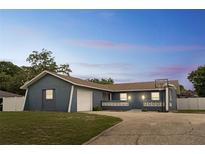Charming single-story home featuring an attached garage, basketball hoop, and well-manicured lawn at 1167 Lake Blanche Dr, Orlando, FL 32808