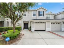 Well maintained two-story townhouse with a two-car garage and manicured landscaping at 14213 Turning Leaf Dr, Orlando, FL 32828