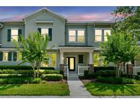 Inviting townhouse exterior with manicured landscaping and charming architectural details at 15477 Blackbead St, Winter Garden, FL 34787
