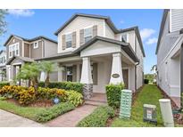 Charming two-story home featuring a landscaped yard, covered porch, and inviting curb appeal in a well-maintained neighborhood at 16013 Tollington Aly, Winter Garden, FL 34787