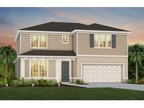 Charming two-story home with a neutral color scheme, two-car garage and lush landscaping at 2267 Mossy Vine Ave, St Cloud, FL 34771