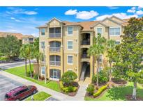Beautiful condo building featuring balconies, lush landscaping and convenient parking at 2821 Almaton Loop # 105, Kissimmee, FL 34747