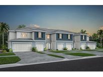 New townhome building featuring two-story construction, painted siding, and individual garages at 3342 Canyon Bay Pt, Sanford, FL 32773
