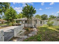 Charming home with a white picket fence, carport, and stone walkway at 3823 Avenue R Nw, Winter Haven, FL 33881