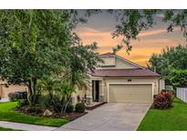 Charming single-Gathering home featuring a well-manicured lawn, two-car garage, and inviting front porch at 5063 Carillon Ln, Windermere, FL 34786