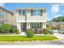 Charming two-story home with meticulously landscaped front yard and inviting curb appeal on a sunny day at 888 Wakulla Ln, Winter Springs, FL 32708