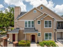 Charming two-story townhouse with neutral siding, complemented by a well-maintained landscape at 1101 Vintage Village Ln # 101, Ocoee, FL 34761