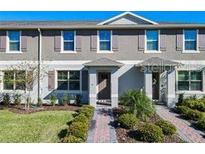 Charming townhome featuring a well-manicured lawn and tasteful exterior color scheme at 12035 Holystone St, Winter Garden, FL 34787