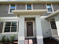 Charming home front entrance, featuring a brick walkway and a covered entryway at 12035 Holystone St, Winter Garden, FL 34787