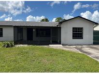 Charming single-story home with a screened porch, freshly painted exterior, and well-maintained lawn at 2085 San Jose Blvd, Orlando, FL 32808