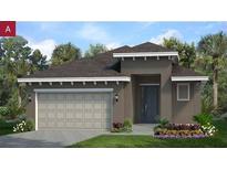 Charming one-story home with a neutral color palette, attached two-car garage, and tropical landscaping at 2276 Sirena Ln, Mount Dora, FL 32757