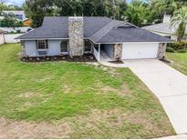 Charming single Gathering home with stone accents and a well-maintained lawn and two car garage at 229 Marcum Trace Dr, Lakeland, FL 33809