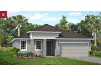 Charming single-story home featuring stone accents, a two-car garage, and professionally landscaped front yard at 2292 Sirena Ln, Mount Dora, FL 32757