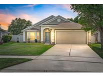 Charming single-Gathering home featuring a well-manicured lawn and a two-car garage at 2913 Wilshire Rd, Clermont, FL 34714