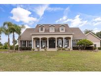 Stunning single story home featuring large front yard and inviting front porch and meticulous landscaping at 3201 Oaklea Dr, Deland, FL 32720