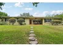 Charming single-story home with a well-manicured lawn and stepping stone pathway leading to the front door at 3312 Se 6Th St, Ocala, FL 34471