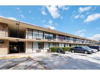 Motel exterior featuring an outdoor balcony and ample parking at 7900 S Orange Blossom Trl # 2108, Orlando, FL 32809