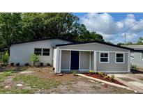 Charming single-story home featuring a freshly painted exterior and a cozy, inviting front porch at 8320 Dominguin St, Orlando, FL 32817