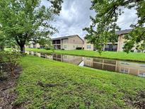 Scenic exterior view of property overlooking a canal, featuring mature trees at 9918 Turf Way # 5, Orlando, FL 32837