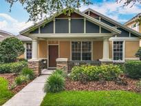 Charming home with a covered front porch, well-maintained landscaping, and a welcoming entrance at 12641 Arley Dr, Windermere, FL 34786
