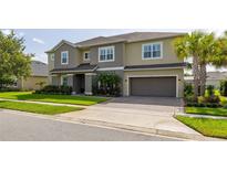 Charming two-story home featuring manicured lawn, a paved driveway, and a two-car garage at 1113 Fieldstone Cir, Oviedo, FL 32765
