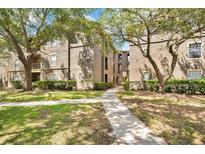Apartment complex with landscaped grounds and walkway leading to entrance at 1321 Arbor Vista Loop # 301, Lake Mary, FL 32746