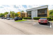 Apartment complex featuring neutral tone exteriors and ample parking for tenant and guest vehicles at 2627 Oak Park Way # 102, Orlando, FL 32822