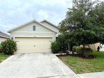 Charming single-Gathering home featuring a well-maintained front yard with beautiful landscaping at 324 Charles Dr, Deland, FL 32724