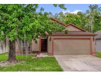 Charming single-story home with a well-maintained lawn and a two-car garage at 3390 Cypress Point Cir, St Cloud, FL 34772