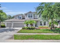 Charming two-story home featuring a well-manicured lawn, a three-car garage, and welcoming curb appeal at 384 Old Alemany Pl, Oviedo, FL 32765