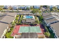 Aerial view showcasing community pool and tennis courts, surrounded by lush landscaping at 6108 Curry Ford Rd # 116, Orlando, FL 32822